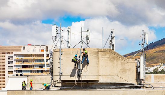 Cape Town, South Africa - November 15, 2022: Electrical workers repairing a telecommunications tower
