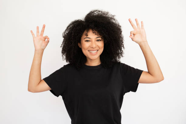 istock Joyful young woman showing OK gestures with both hands 1448712522