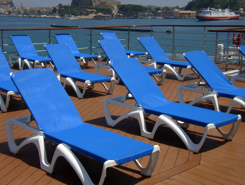 Blue Loungers in the deck of a cruiser near the pool                                                               