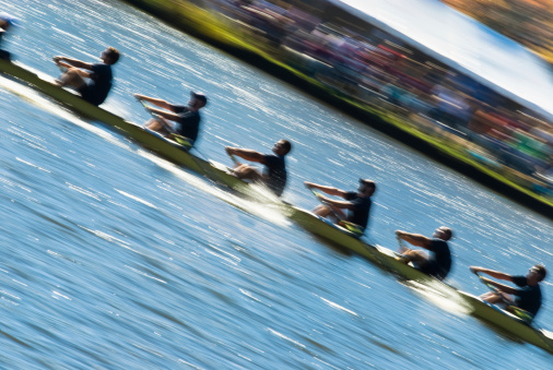 Speeding rowing boat with motion blur to accent speed.