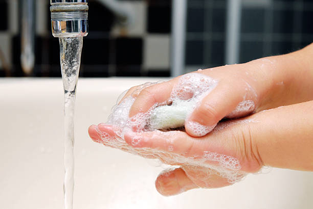 Washing her little hands stock photo