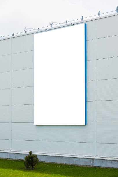 istock Mock up template. Big vertical white blank signboard, advertising billboard on modern building wall outdoors 1448717561