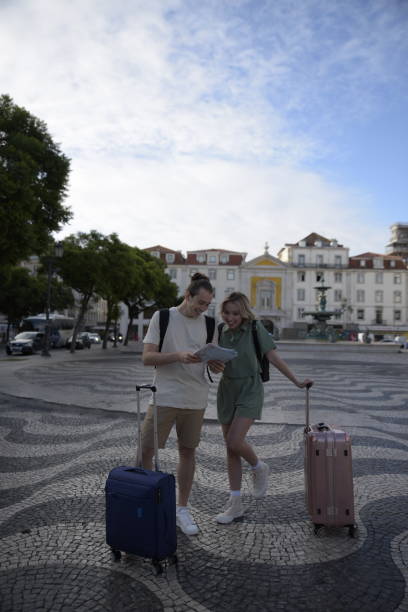 istock Thrilled tourist couple with map 1448718514