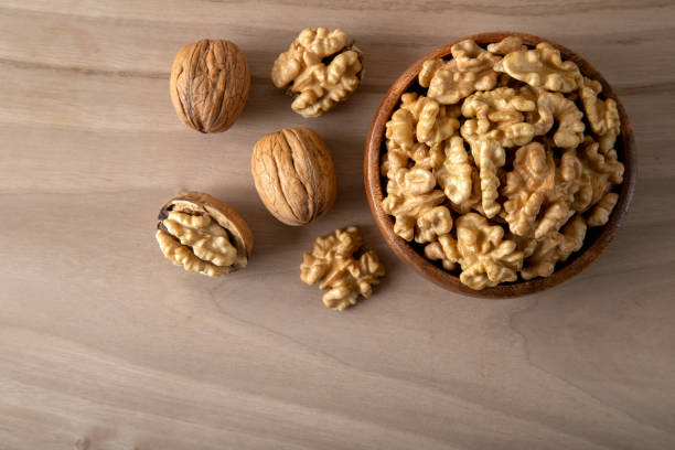istock Group of peeled walnuts and whole walnuts,directly above 1448719965