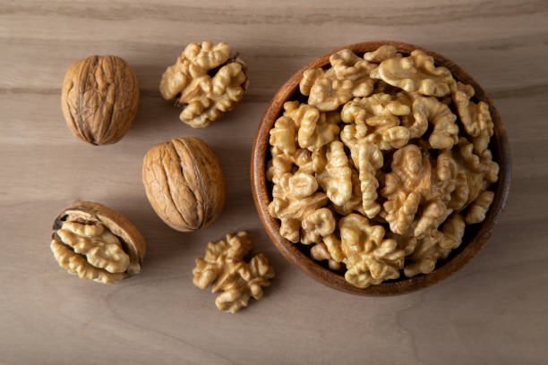 istock Group of peeled walnuts and whole walnuts,directly above 1448720069