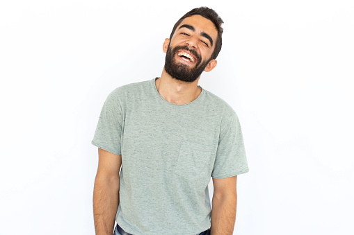 Happy man laughing. Young male model expressing joy. Portrait, studio shot, happiness concept