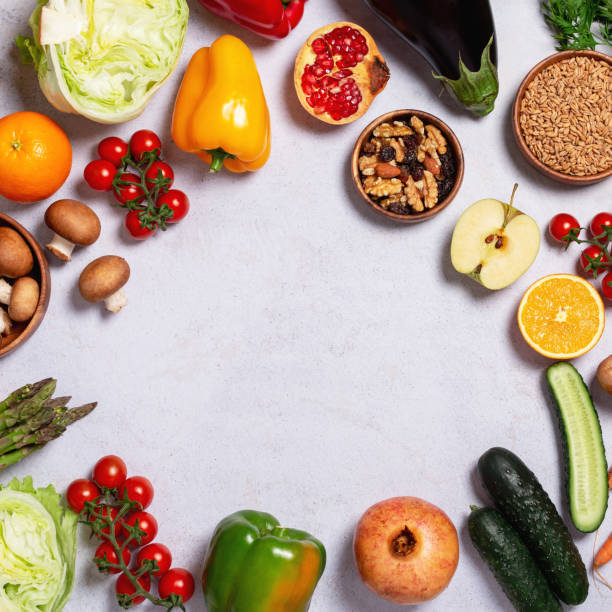 istock Square frame, border with raw fresh vegetables and fruits on table, copy space 1448720768