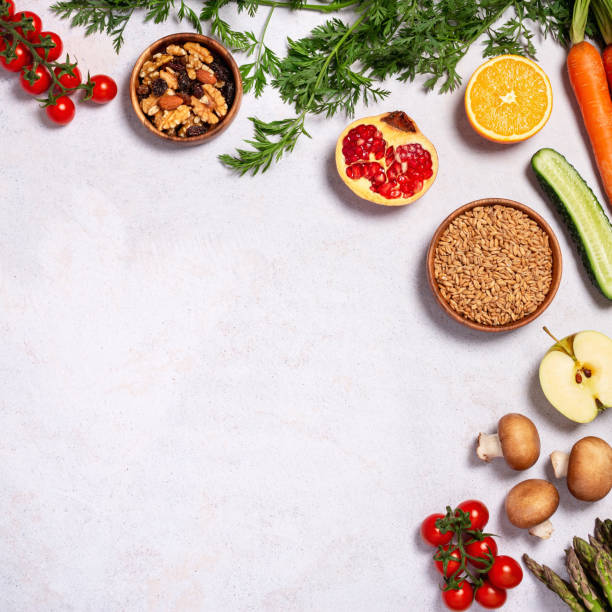 istock Square frame, border with raw fresh vegetables and fruits on table, copy space 1448720777