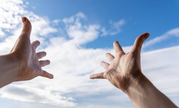 istock Hands of a man reaching to sky. 1448721029