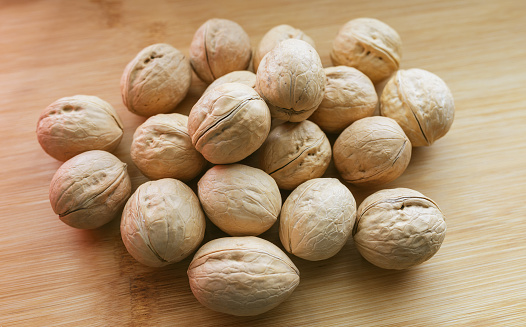 Walnuts on wooden background. Selective focus with shallow depth of field.