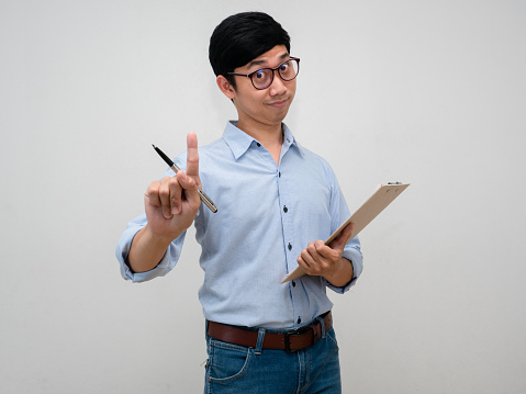 Young businessman wear glasses show finger up number one and holding document board confident looking isolated