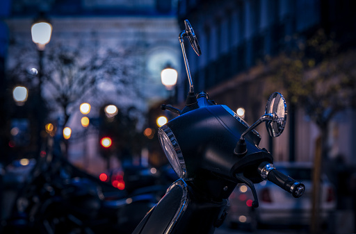 Closeup of motorbike on street at night. Madrid, Spain