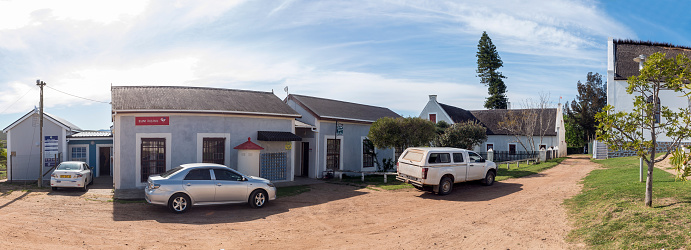 Elim, South Africa - Sep 21, 2022: A street scene, with historic buildings, in Elim, in the Western Cape Province. A clinic, post office and the Moravian Church are visible