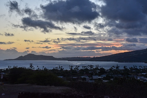 A landscape from the southshore of Oahu looking towards Diamond Head at sunset.