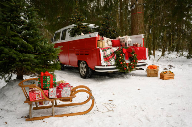 istock A red car with Christmas decorations and a Christmas tree is standing in a winter forest. Festive New Year concept. 1448725702