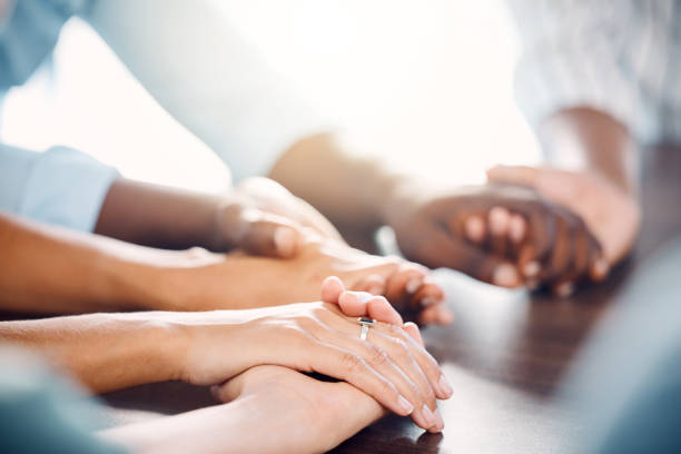 istock Diversity, hand holding and support for trust, community and hope in unity or teamwork together indoors. Hands of people in collaboration, solidarity and faith for group meeting, therapy and care 1448725817