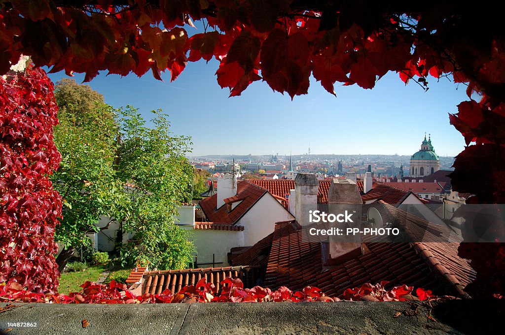 Prague City Prague city, capital of the Czech Republic, viewed out of window framed with autumn colored foliage. Architecture Stock Photo