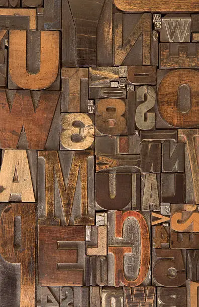 An assortment of old wooden and metal type blocks