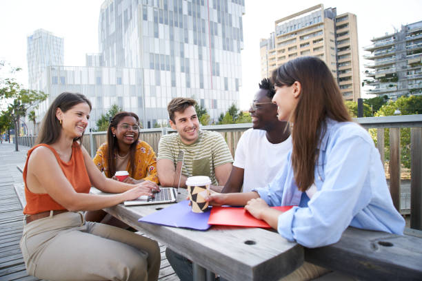 istock Group of cheerful students studying together outdoors. College classmates review for exam together 1448731632