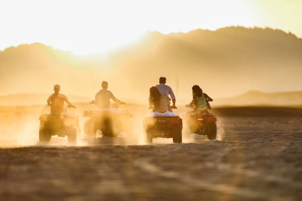 istock Driving quad bikes in the desert at sunset! 1448732885