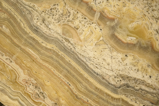 an unusual yellow-red beautiful onyx with streaks and stains in the slab