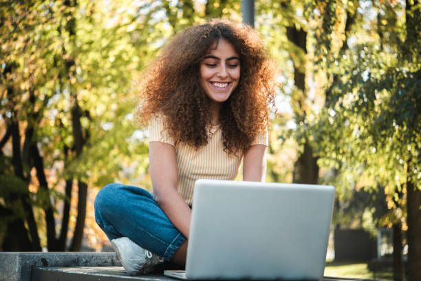 istock Beautiful girl freelancing from the park 1448734052