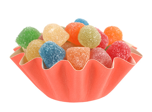 Here are jelly sweets colorful candies gumdrops are in paper cup box.