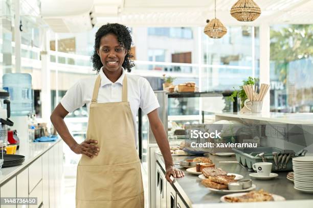 Portrait Of Confident Food Server Behind The Counter Stock Photo - Download Image Now