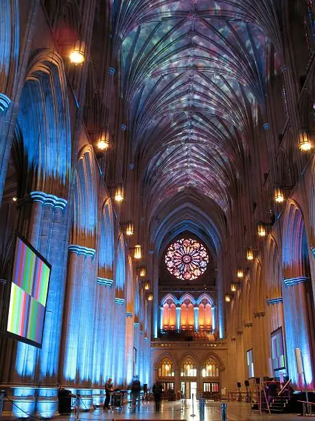 Photo of the sanctuary of the National Cathedral in Washington D.C. lit by psychedelic colors.  This is in preparation for the 100 year or centennial celebration 