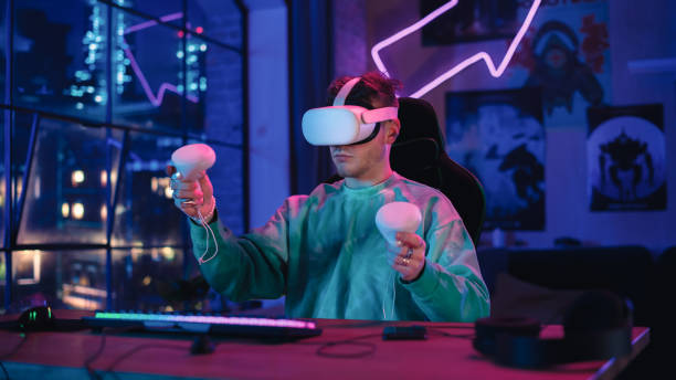 Stylish Man Using Virtual Reality Headset with Controllers at Home in Loft Apartment. Young Male Browsing Online, Spending Time in VR Software and Digital Office. POV from Screen Perspective. hombre elegante que usa auriculares de realidad virtual con controladores en casa en un apartamento tipo loft. hombre joven navegando en línea, pasando tiempo en software de realidad virtual y oficina digital. pov desde la perspectiva de la pantalla.