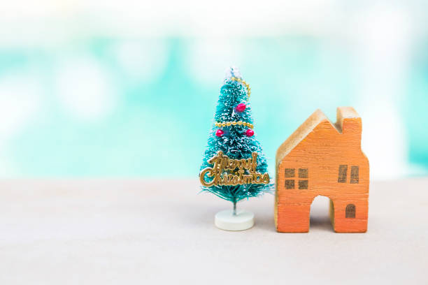 istock Wooden orange house with Christmas tree with space on blurred background 1448738968