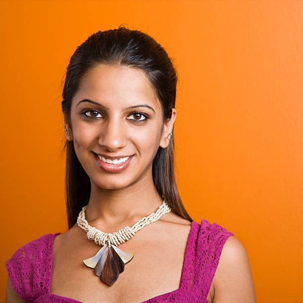 Attractive young adult Indian woman smiling at viewer.