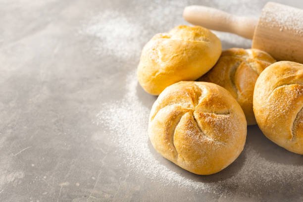 istock Mini bun bread on white background with rolling pin copy space. Home baking concept 1448740769