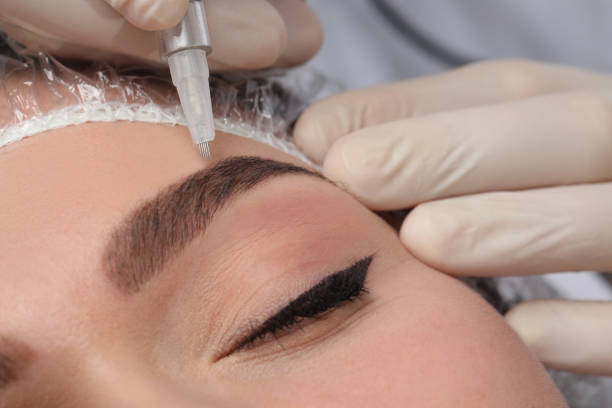istock Young woman during procedure of permanent eyebrow makeup, closeup 1448743911