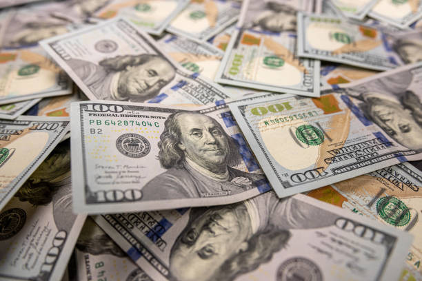 istock large amount of US dollars isolated on a black background. 1448744472