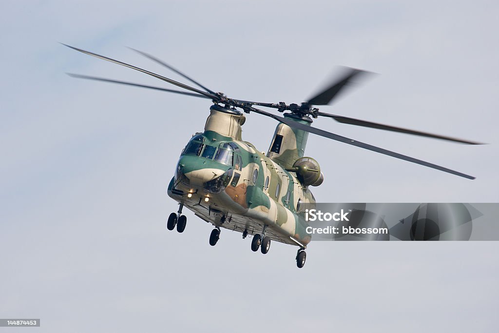 Chinook Helicopter (front view) A CH-47 transport helicopter flying under a blue sky with thin cloud cover. Air Force Stock Photo