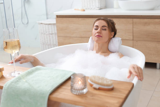 istock Beautiful woman enjoying bubble bath at home 1448744623