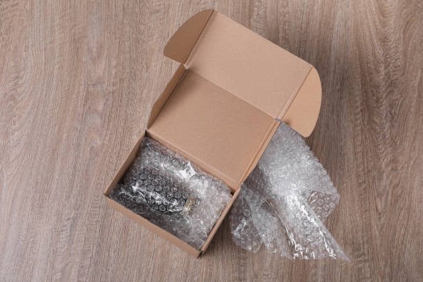 istock Jar in cardboard box and bubble pack on wooden table, top view 1448746986