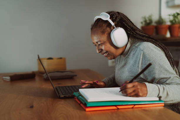 istock Senior African woman working on a laptop at home - Smart work and Technology concept 1448747068