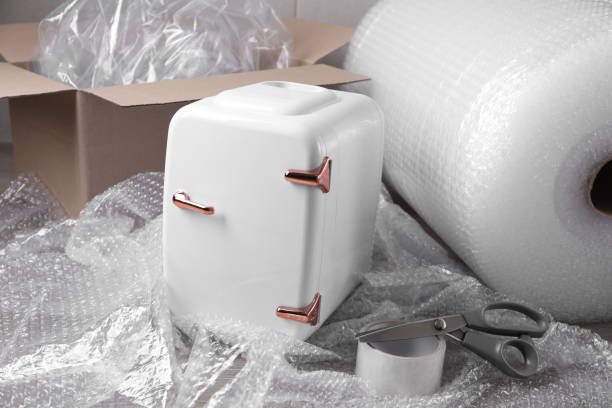 istock Cosmetics refrigerator with bubble pack, scissors and adhesive tape on table 1448747923