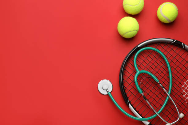 istock Tennis racket, balls and stethoscope on red background, flat lay with space for text. Doping concept 1448748123