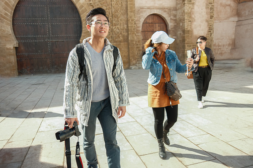 Asian Chinese tourist arrive walking in alley of Kasbah of the Udayas on sunny day