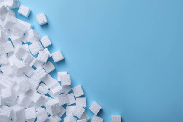 istock Many styrofoam cubes on light blue background, flat lay. Space for text 1448748634