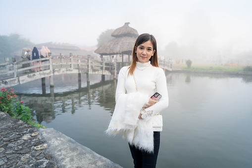 Woman traveling in the Yun Lai village with the mist in the morning, Yun Lai Village is a Chinese-Thai community living in the northern part of Thailand. It is an interesting tourist spot. And most tourists visit during the winter at Pai, Mae Hong Son province, Thailand.