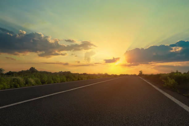 istock View of empty asphalt road at sunset 1448749866