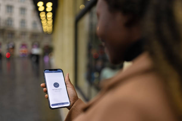 istock Black woman signing in to a mobile app 1448753702