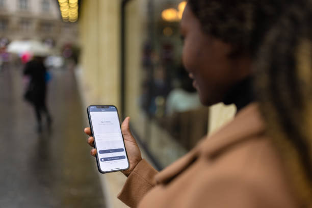 istock Black woman signing in to a mobile app 1448753705