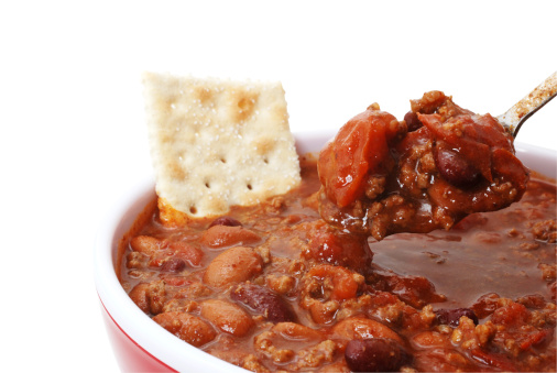 Bowl of hot chili with beans and cracker.  Isolated on white background with clipping path.