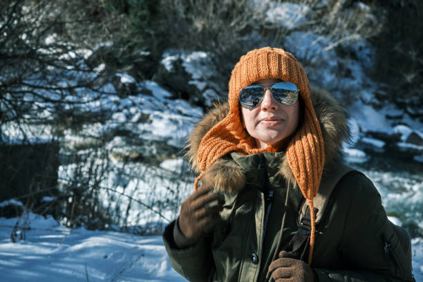 istock Mature woman in winter mountains is looking around 1448755963