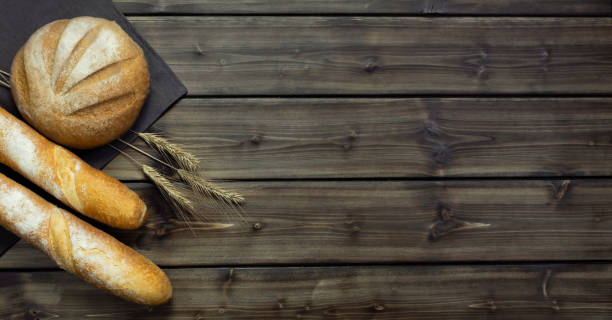 istock Rye and wheat bread on a wooden background. 1448757391